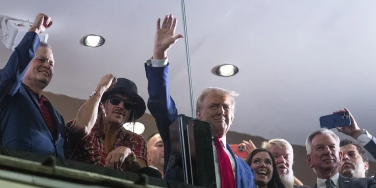 In Alabama, Trump shifts from the dark language of his campaign to the adoration of college football fans.